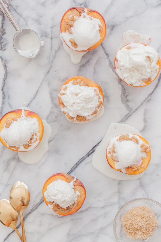 Baked peaches with crisp topping served with vanilla ice-cream.