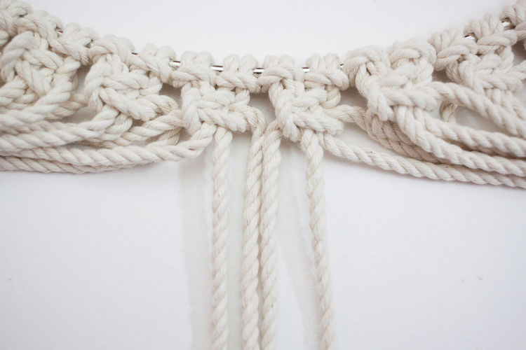 Tying alternating square knots to make a DIY Macrame Mirror